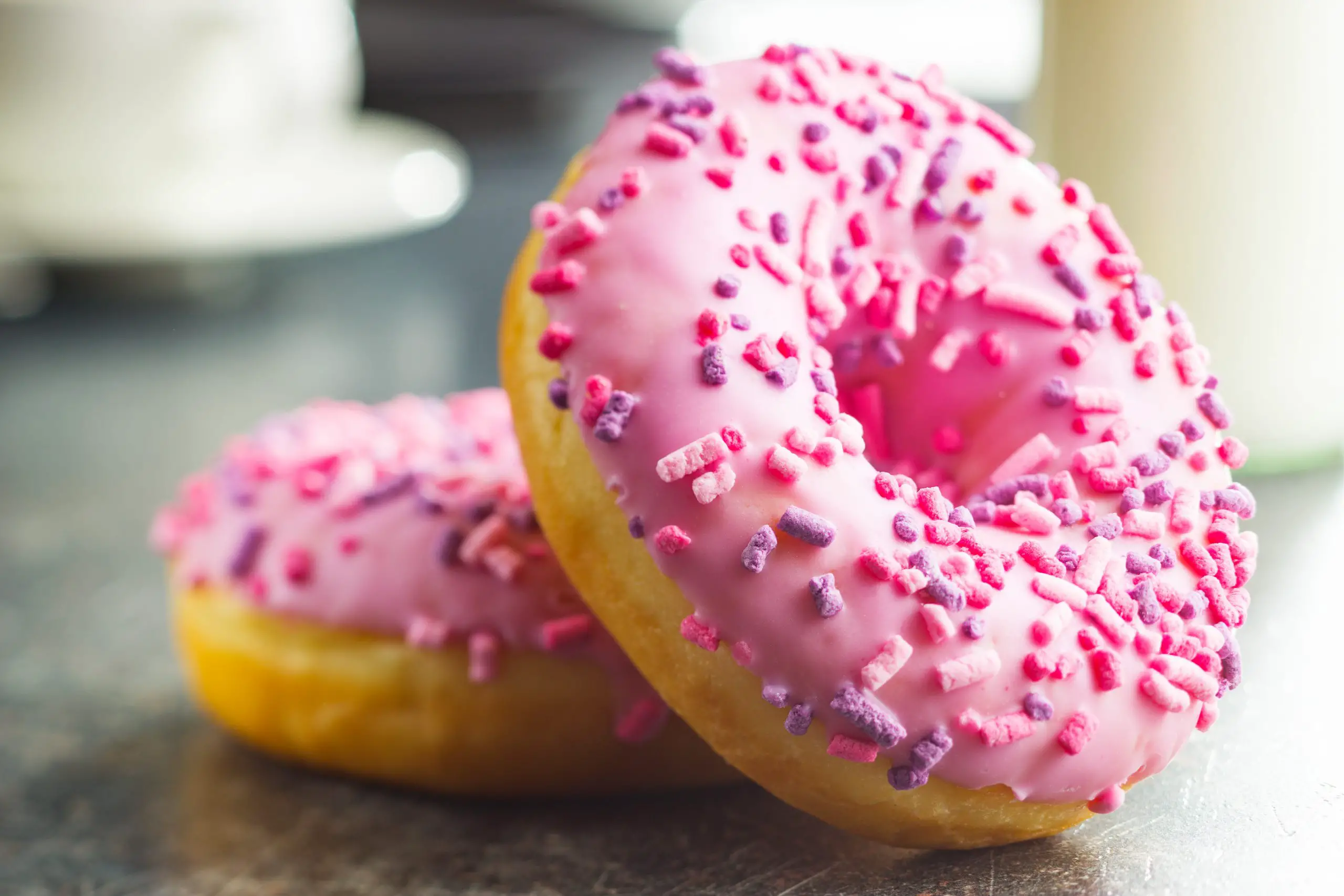 two pink frosted donuts